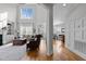 Open-concept living room with high ceilings, hardwood floors, and plentiful natural light at 233 Candia Ln, Cary, NC 27519