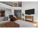 Two-story living room featuring hardwood floors, large windows, and a comfortable seating area at 233 Candia Ln, Cary, NC 27519