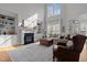 Bright living room boasts a fireplace, built-in shelving, and large windows at 233 Candia Ln, Cary, NC 27519