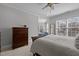 Spacious main bedroom with a calming color palette, hardwood furniture, and a secondary sitting area with plenty of natural light at 233 Candia Ln, Cary, NC 27519