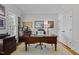 Home office featuring a dark wooden desk, neutral walls, and natural light from the window at 233 Candia Ln, Cary, NC 27519