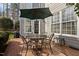 Back patio with outdoor seating, a black grill, and an umbrella for shade perfect for relaxing outdoors at 233 Candia Ln, Cary, NC 27519