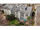 Aerial view of the house with a manicured lawn, shrubbery, and patio seating at 233 Candia Ln, Cary, NC 27519
