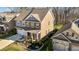 Aerial view of a two-story brick and gray home with a manicured front yard and a detached garage at 234 Macallan Dr, Burlington, NC 27215