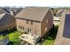 Brick home featuring a patio with outdoor seating, plus a trampoline in a grassy backyard at 234 Macallan Dr, Burlington, NC 27215