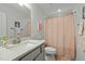 Bathroom with a large mirror, neutral walls, modern fixtures, and a polka dot shower curtain at 234 Macallan Dr, Burlington, NC 27215