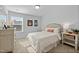 Cozy bedroom features a comfortable bed with bright sunlight streaming in through the window at 234 Macallan Dr, Burlington, NC 27215