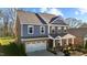 Charming two-story home with a covered front porch, brick and stone accents, and a well-manicured front yard at 234 Macallan Dr, Burlington, NC 27215