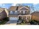Charming two-story home with a covered front porch, brick and stone accents, and a well-manicured front yard at 234 Macallan Dr, Burlington, NC 27215
