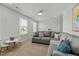 Bright living room with a large sectional sofa, white walls, and large windows for natural light at 234 Macallan Dr, Burlington, NC 27215