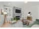 Inviting living room features a stone fireplace, built-in shelving, and comfortable seating arrangements at 234 Macallan Dr, Burlington, NC 27215