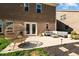 Brick home featuring a patio with a hanging chair and outdoor furniture at 234 Macallan Dr, Burlington, NC 27215