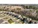 Aerial view of a residential street showcasing the neighborhood's well-manicured lawns and mature trees at 234 Macallan Dr, Burlington, NC 27215