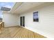 Back of the house with wooden deck, white siding, and an open backyard at 239 Surles Rd, Benson, NC 27504