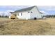 Back of home with wooden deck, white siding and large backyard at 239 Surles Rd, Benson, NC 27504