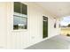 Charming front porch has olive green door, a window, and white siding at 239 Surles Rd, Benson, NC 27504