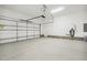 Spacious garage with a rolling garage door, water heater, and door to the house at 239 Surles Rd, Benson, NC 27504