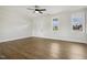 Bright living room featuring a ceiling fan, wood-look floors, and neutral paint at 239 Surles Rd, Benson, NC 27504