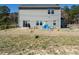 View of the backyard featuring a playset, patio with grill, and a large grassy area at 2575 Sheriff Watson Rd, Sanford, NC 27332