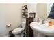 Powder room with pedestal sink, three shelves with decor and a butterfly picture at 2575 Sheriff Watson Rd, Sanford, NC 27332