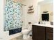 Bathroom with a shower tub, patterned whale shower curtain, vanity with a white countertop, and decorations at 2575 Sheriff Watson Rd, Sanford, NC 27332