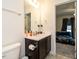 Bathroom featuring a white countertop sink with brown vanity cabinet, and a toilet to the side at 2575 Sheriff Watson Rd, Sanford, NC 27332