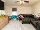 Bedroom featuring a large sectional sofa, ceiling fan, and light gray carpet at 2575 Sheriff Watson Rd, Sanford, NC 27332