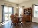 Cozy dining area with wood table, chairs, and sliding door to a picturesque outdoor view and decor at 2575 Sheriff Watson Rd, Sanford, NC 27332