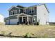 Two-story home boasts well-maintained landscaping and a spacious two-car garage, all set against a blue sky at 2575 Sheriff Watson Rd, Sanford, NC 27332