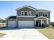Charming two-story home features a two-car garage and a welcoming front porch with stylish columns at 2575 Sheriff Watson Rd, Sanford, NC 27332