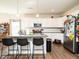 Modern kitchen featuring white cabinets, stainless steel appliances, granite countertops, and an island with seating at 2575 Sheriff Watson Rd, Sanford, NC 27332
