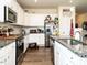 Well-lit kitchen features granite counters, stainless steel appliances, wood flooring, and white cabinets at 2575 Sheriff Watson Rd, Sanford, NC 27332