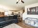 Open living room and kitchen area with modern appliances, an island with seating, and comfortable gray couches at 2575 Sheriff Watson Rd, Sanford, NC 27332