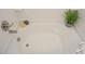 Bright white bathtub with decorative items and plants in a modern bathroom at 274 Deodora Ln, Cameron, NC 28326