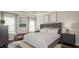 Well-lit bedroom with a grey tufted bed, bench, and matching nightstands at 274 Deodora Ln, Cameron, NC 28326