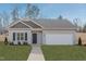 Inviting single-story home with a well-manicured lawn, neutral siding, and a two-car garage at 274 Deodora Ln, Cameron, NC 28326