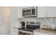 This kitchen features granite counters, stainless appliances, and white subway tile backsplash at 274 Deodora Ln, Cameron, NC 28326