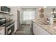 Well-lit kitchen showcasing granite counters, stainless steel appliances, and ample storage at 274 Deodora Ln, Cameron, NC 28326