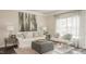 Cozy living room with a white sofa, patterned chairs, decor, and large windows at 274 Deodora Ln, Cameron, NC 28326