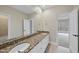 Bright bathroom featuring a granite countertop vanity, and sinks, and a neutral color palette at 2803 Cameron Pond Dr, Cary, NC 27519