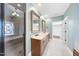 Spacious bathroom features dual sinks, large mirrors, walk-in shower, and separate bathtub at 2803 Cameron Pond Dr, Cary, NC 27519