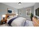 Relaxing bedroom featuring light-colored walls, two windows, and modern decor at 2803 Cameron Pond Dr, Cary, NC 27519