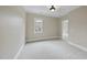 Bright bedroom with neutral walls, plush carpet, and a window letting in natural light at 2803 Cameron Pond Dr, Cary, NC 27519