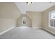 Bright bedroom featuring neutral walls, carpeting, and unique window shape at 2803 Cameron Pond Dr, Cary, NC 27519