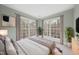 This bedroom boasts views of the surrounding wooded area, light gray walls, and neutral decor at 2803 Cameron Pond Dr, Cary, NC 27519