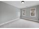 Neutral bedroom with plush carpet, crown molding, and bright natural light from two windows at 2803 Cameron Pond Dr, Cary, NC 27519