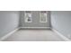 Neutral bedroom with plush carpet, crown molding, and two windows, ideal for relaxation at 2803 Cameron Pond Dr, Cary, NC 27519