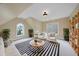 Bright bonus room featuring a vaulted ceiling, plenty of sunlight, and unique architecture at 2803 Cameron Pond Dr, Cary, NC 27519