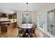 Kitchen and dining area with hardwood floors, modern lighting, and natural light at 2803 Cameron Pond Dr, Cary, NC 27519