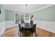 Dining room featuring hardwood floors, modern chandelier, and neutral wall colors at 2803 Cameron Pond Dr, Cary, NC 27519